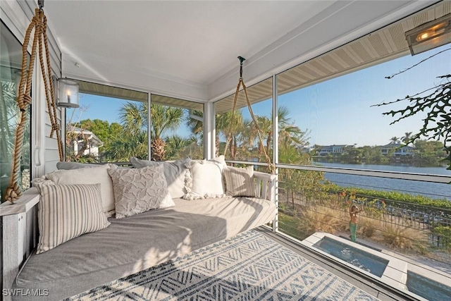 sunroom featuring a water view and a healthy amount of sunlight