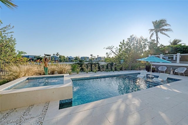 view of pool featuring pool water feature, a patio area, and an in ground hot tub