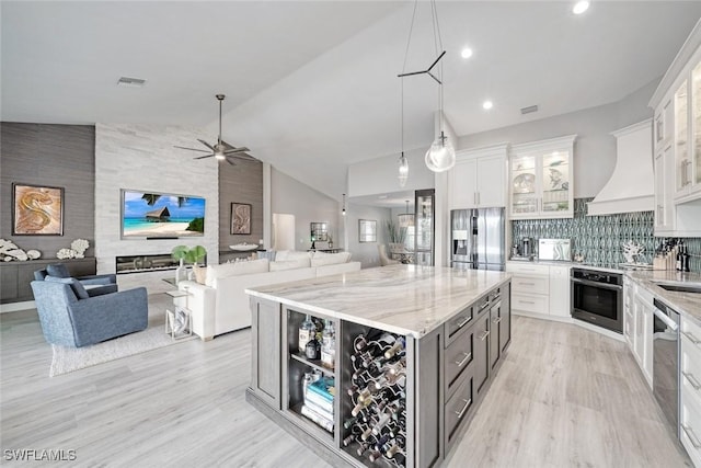 kitchen featuring appliances with stainless steel finishes, white cabinetry, and a spacious island