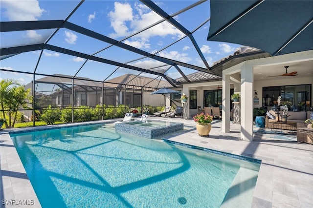 view of pool featuring a lanai, ceiling fan, an outdoor hangout area, an in ground hot tub, and a patio