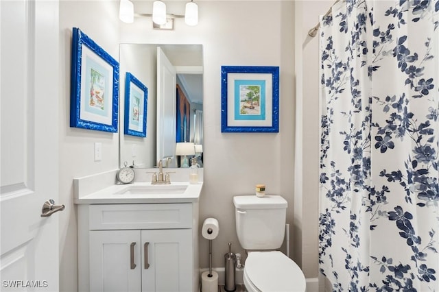 bathroom featuring toilet, a shower with curtain, and vanity