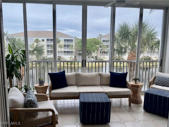 sunroom / solarium featuring a water view