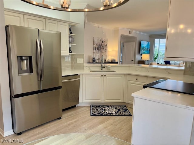 kitchen featuring sink, ornamental molding, decorative backsplash, and stainless steel appliances