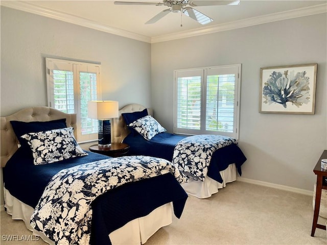 carpeted bedroom with ceiling fan and ornamental molding