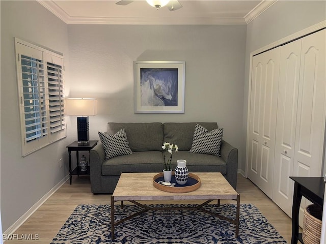 living room featuring ceiling fan, crown molding, and light wood-type flooring