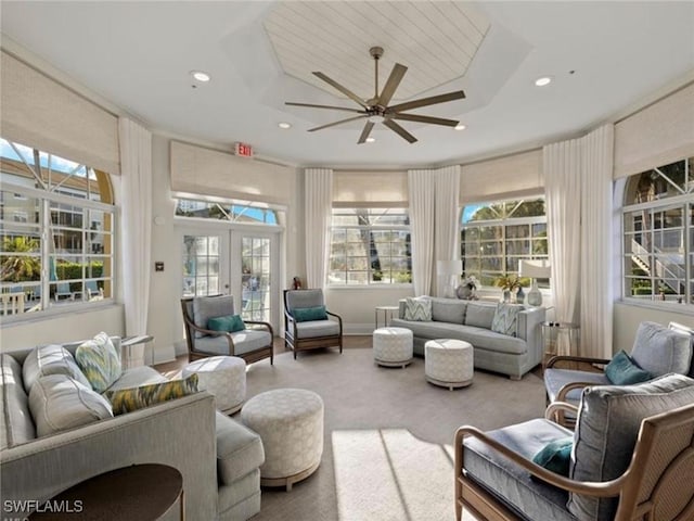 sunroom / solarium featuring ceiling fan, a wealth of natural light, and french doors