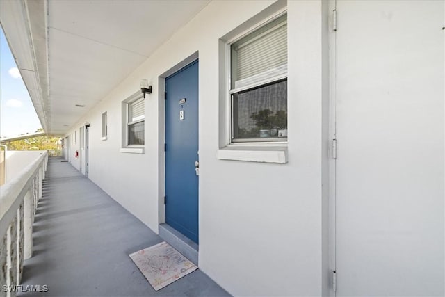 view of exterior entry with a balcony