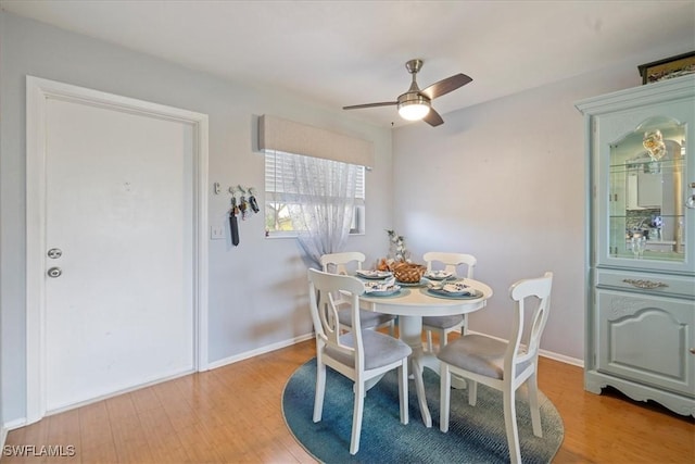 dining space with ceiling fan and light hardwood / wood-style floors