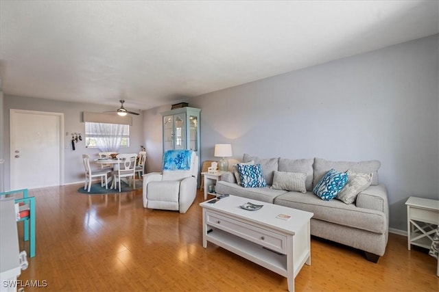 living room with ceiling fan and light hardwood / wood-style floors