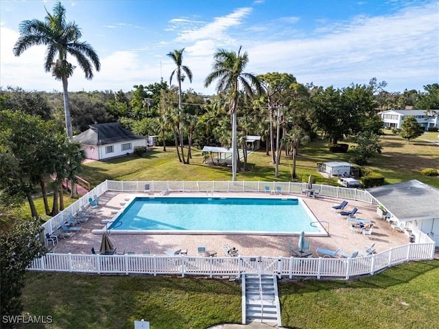 view of swimming pool featuring a yard and a patio