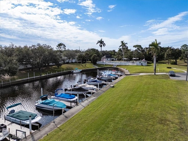 dock area with a yard and a water view