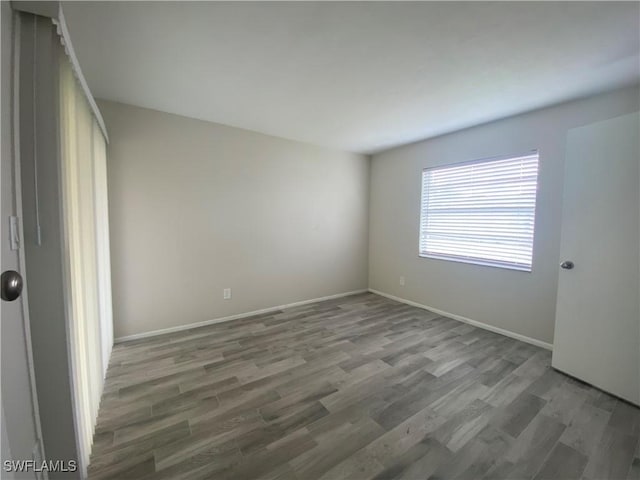 spare room with dark wood-type flooring