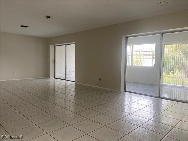 unfurnished room featuring light tile patterned floors