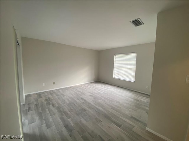 spare room with hardwood / wood-style floors