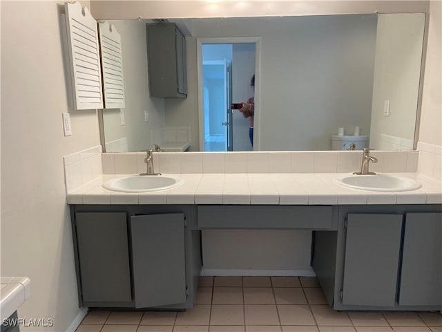 bathroom featuring vanity, toilet, and tile patterned flooring