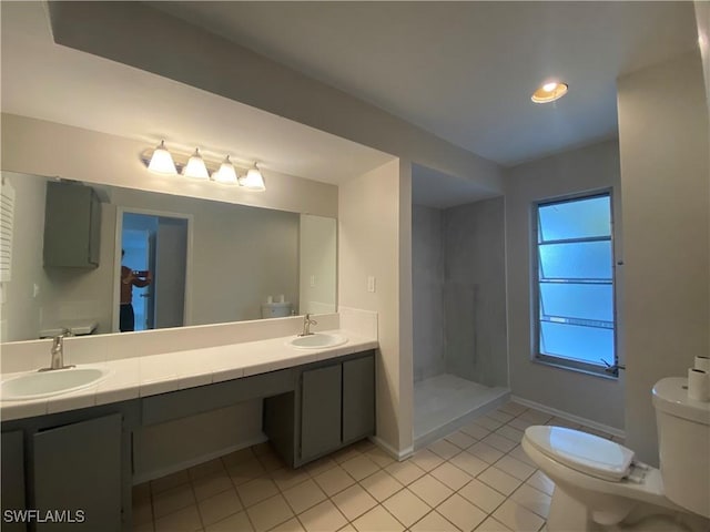 bathroom with vanity, tile patterned floors, toilet, and walk in shower