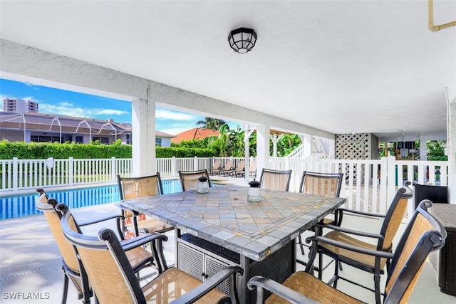 view of patio / terrace featuring exterior bar and a fenced in pool