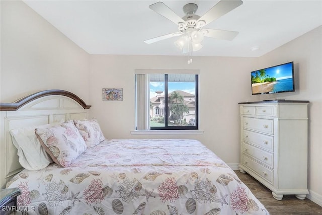 bedroom featuring ceiling fan and dark hardwood / wood-style floors