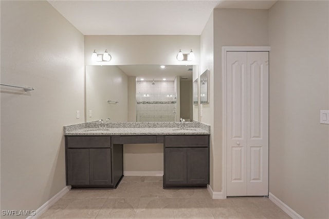 bathroom with vanity, tile patterned floors, and tiled shower