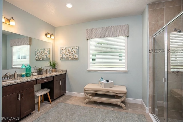 bathroom featuring tile patterned floors, plenty of natural light, and walk in shower