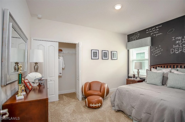 bedroom with light carpet, a closet, and a textured ceiling