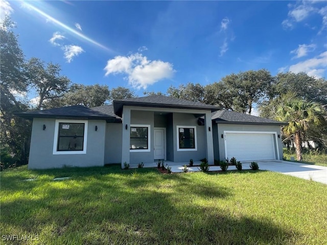 view of front of house with a front yard and a garage