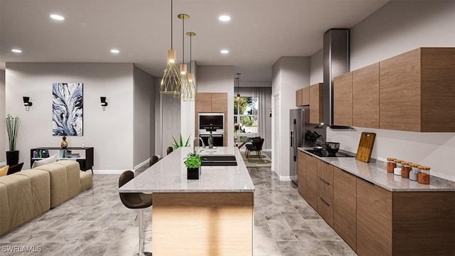 kitchen featuring a center island with sink, stainless steel appliances, hanging light fixtures, a breakfast bar, and sink