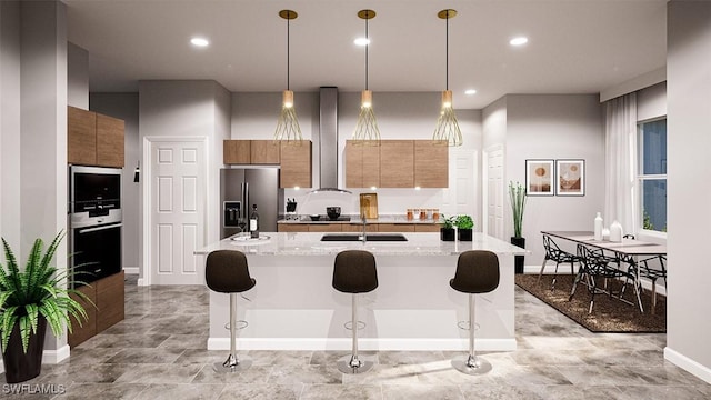 kitchen with pendant lighting, stainless steel refrigerator with ice dispenser, a kitchen island with sink, light stone counters, and a breakfast bar