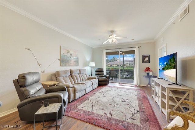 living room with crown molding, wood-type flooring, and ceiling fan