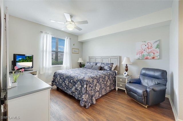 bedroom with ceiling fan and dark wood-type flooring