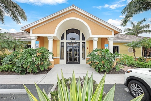 view of exterior entry featuring french doors