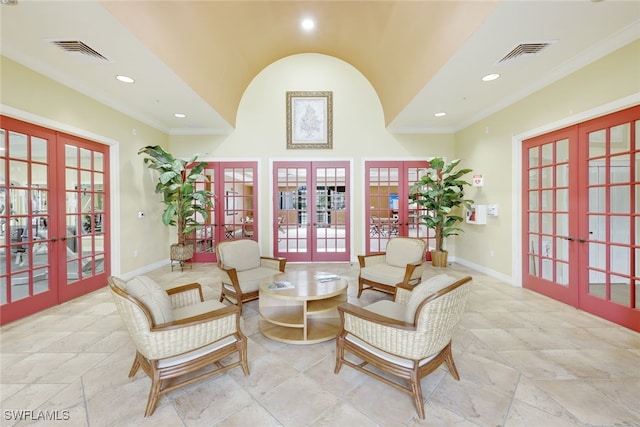 sitting room with ornamental molding and french doors