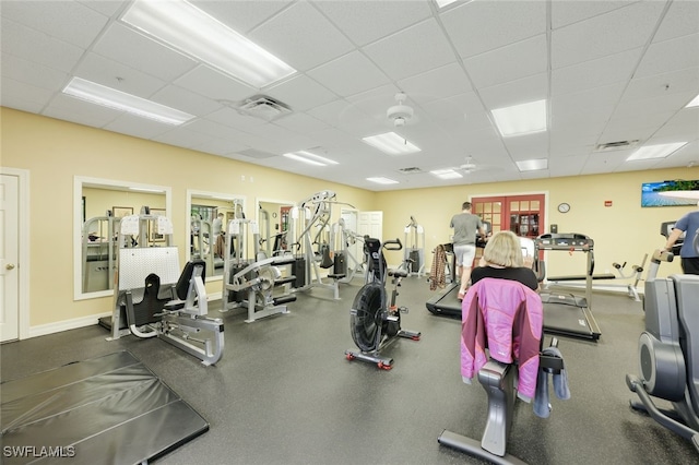 gym with a paneled ceiling