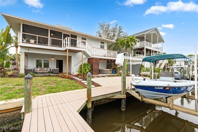 dock area featuring central air condition unit, a water view, and a yard