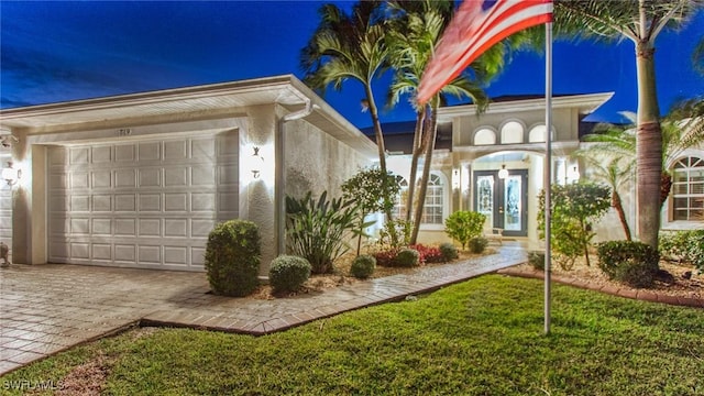 view of front of home featuring a garage and a front lawn