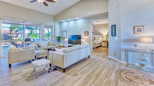 living room with ceiling fan, light hardwood / wood-style flooring, and high vaulted ceiling