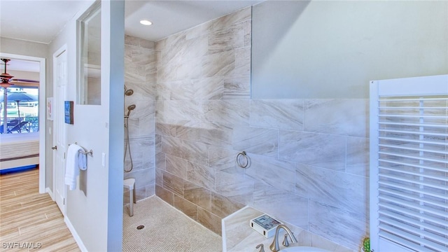 bathroom featuring hardwood / wood-style floors and tiled shower