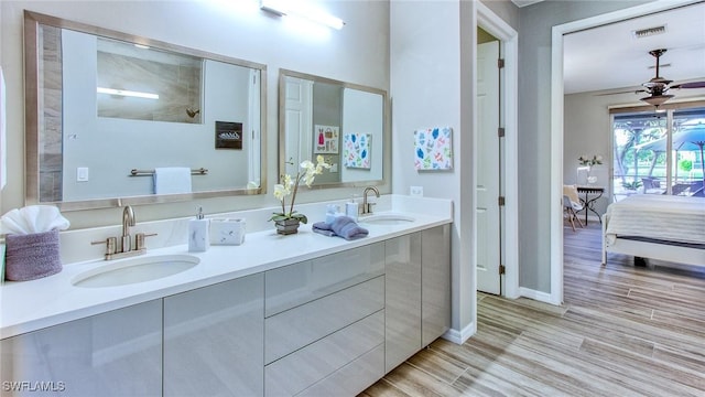 bathroom featuring ceiling fan, hardwood / wood-style floors, and vanity