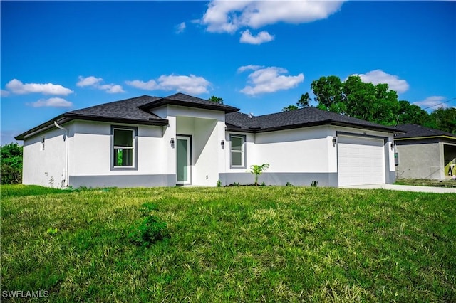 view of front of house with a front yard and a garage