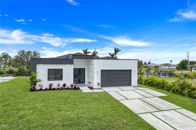 view of front of house featuring concrete driveway, a front lawn, an attached garage, and stucco siding