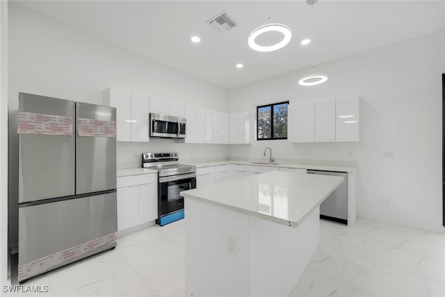 kitchen featuring modern cabinets, appliances with stainless steel finishes, marble finish floor, white cabinetry, and a sink