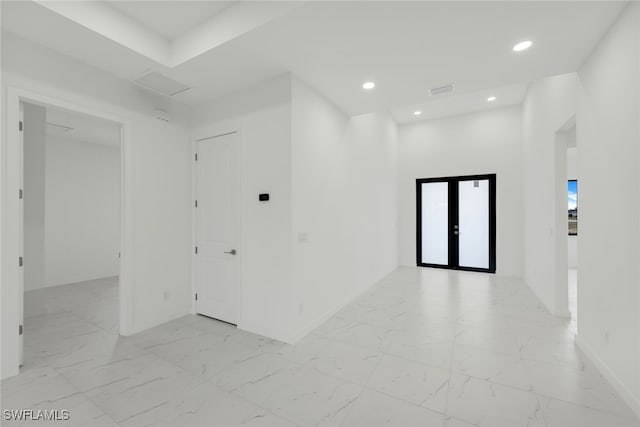 spare room with recessed lighting, marble finish floor, baseboards, and french doors