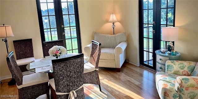 sitting room with light hardwood / wood-style flooring and french doors