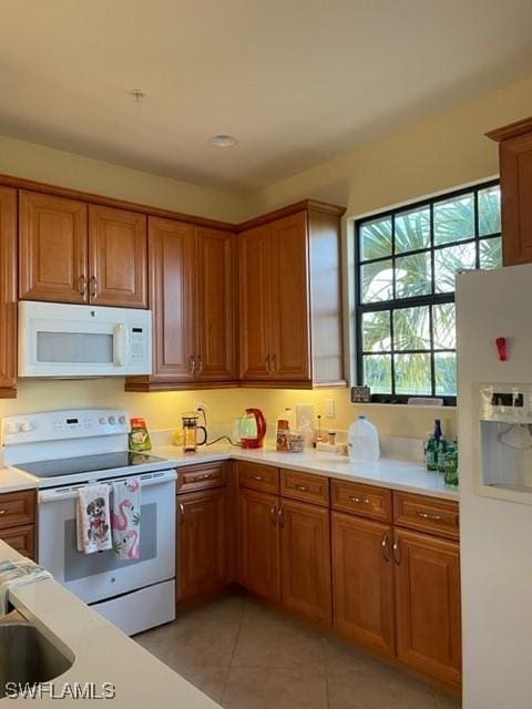 kitchen with light tile patterned floors and white appliances