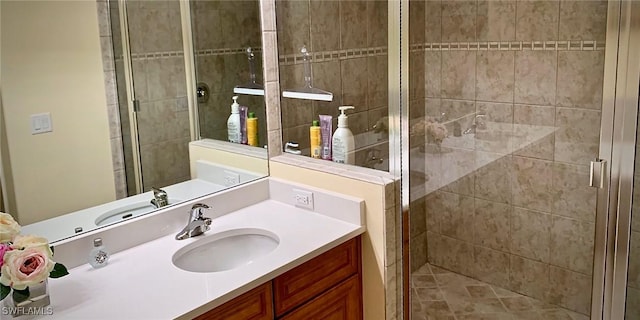 bathroom with vanity and a shower with door