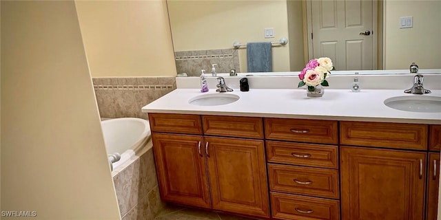 bathroom featuring vanity, tile walls, tile patterned floors, and tiled tub