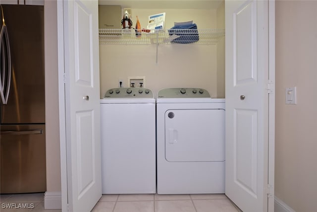 laundry room with light tile patterned floors and separate washer and dryer