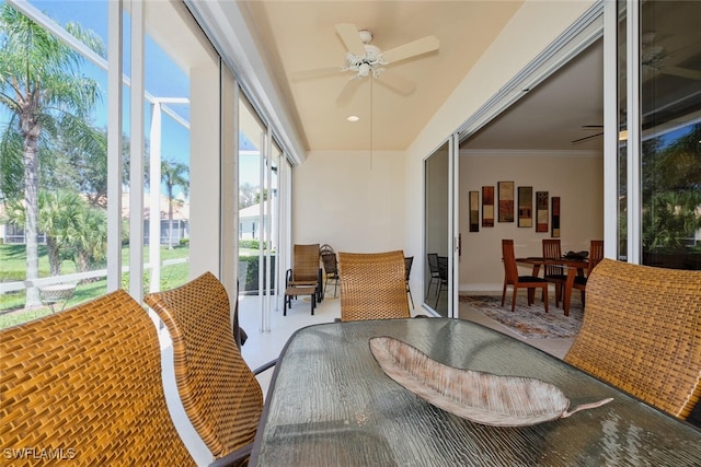 sunroom / solarium featuring ceiling fan