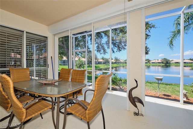 sunroom featuring a water view and a healthy amount of sunlight