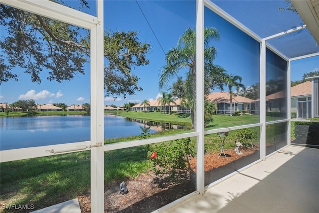 unfurnished sunroom with a water view